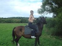 Teen topless horse-riding