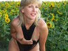 Blonde amateur wife posing at sunflowers field