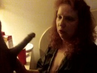 Redhead mom sucking on black popsicle