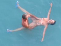 Two people fuck at the beach