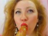 Redhead is sticking a dildo in