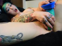 A tattooed chick is fooling around