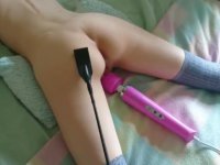 Young little girl having fun with a vibrator and receiving blows in the ass