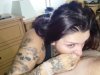 Brunette in a tattoo takes a deep blowjob