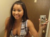 Smiling Girl Shows Some Cleavage In The Mirror
