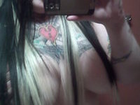 Tattooed Chick Displays Her Huge Boobs