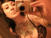 Tattooed Chick Displays Her Huge Boobs
