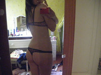 Hot Brunette In Front Of The Mirror