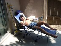 Sunbathing topless and teasing