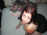 Kinky tattooed darling posing