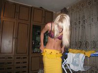 Cute blonde undressing at home