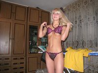 Cute blonde undressing at home