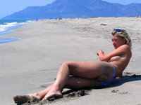 Amateur blonde sunbathing topless