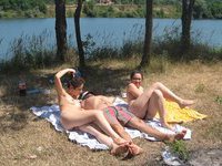 One lucky guy sunbathing with three hot girls