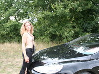My wife posing at my car