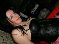 Busty brunette in leather corset