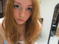 Redhead amateur girl posing at home