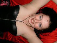 Busty brunette at leather corset