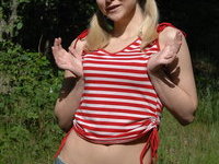 Naked blonde posing outdoors