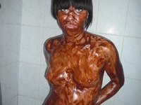 Brunette takes a chocolate bath