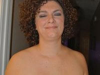Curly haired busty Milf