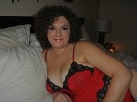 Curly haired busty Milf