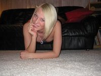 Sexy blonde babe posing on sofa
