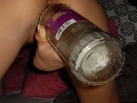 Sweet young babe with bottle in her pussy