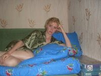 Redhair girl posing on bed