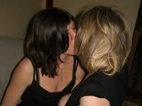 Two amateur moms kissing and posing
