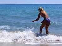 Amateur blonde wife poses naked on beach