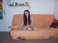 Teen playing naked on her bed