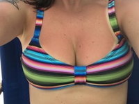 Sun tanned MILF with natural tits