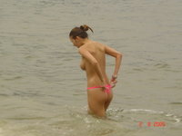 Four cute amateur girls topless at seaside