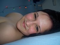 Chubby busty amateur girl posing on bed