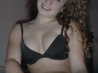 Curly amateur GF posing on bed
