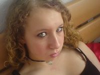 Curly amateur GF posing on bed