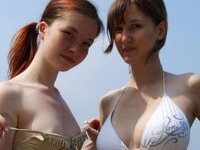 Two amateur teen GFs posing together at lake