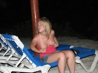Cute blond girl showing tits at beach