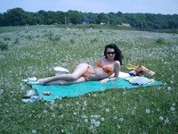 Amateur brunette sunbathing topless