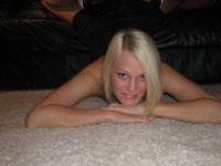Seductive amateur blonde posing on leather sofa