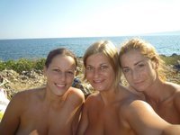 Three topless girls at picnic
