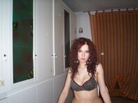 Sexy redhead babe posing in her room