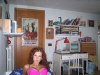 Sexy redhead babe posing in her room