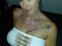 Sexy busty tattooed edheaded MILF sexlife pics