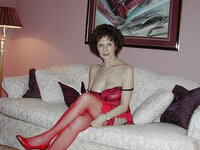 Mature amateur brunette posing on sofa