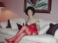 Mature amateur brunette posing on sofa