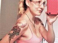 Nerdy but sexy blonde with tattooes