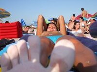 Curly amateur brunette topless at beach