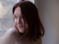 Curvy redhead with pierced nipples nude posing